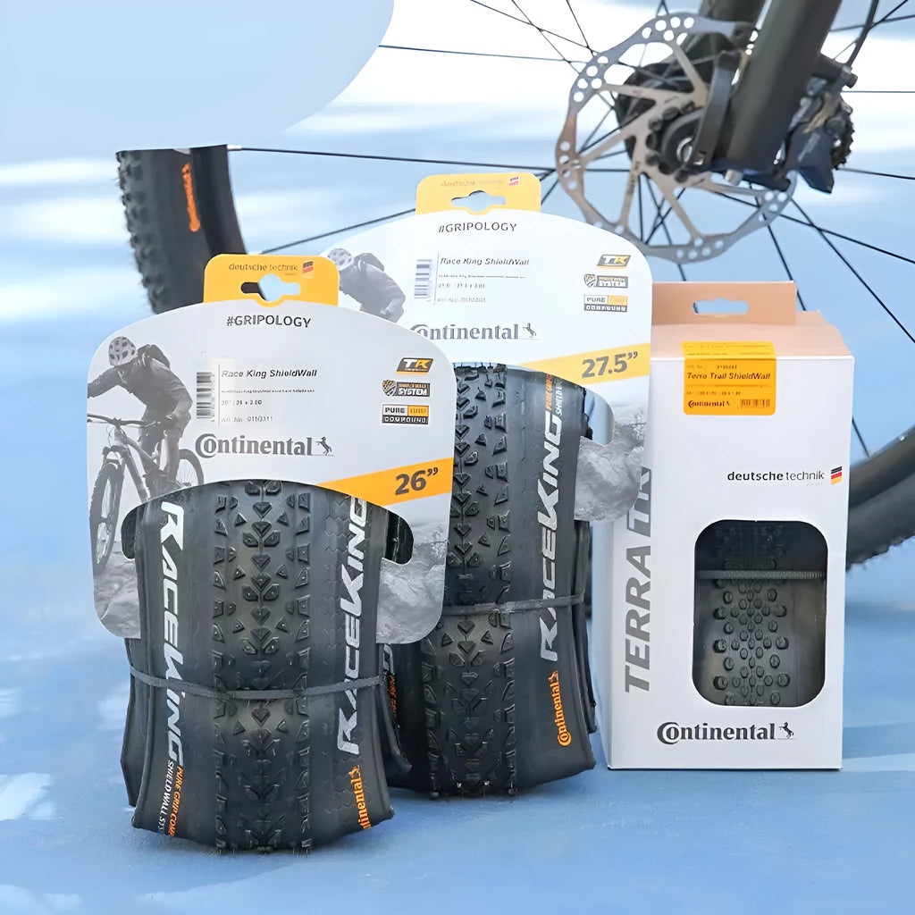 Mountain bike outer tyre showing yellow sidewall, labelled with sizes 26, 27.5, 29 inches and 2.0, 2.2 width options.