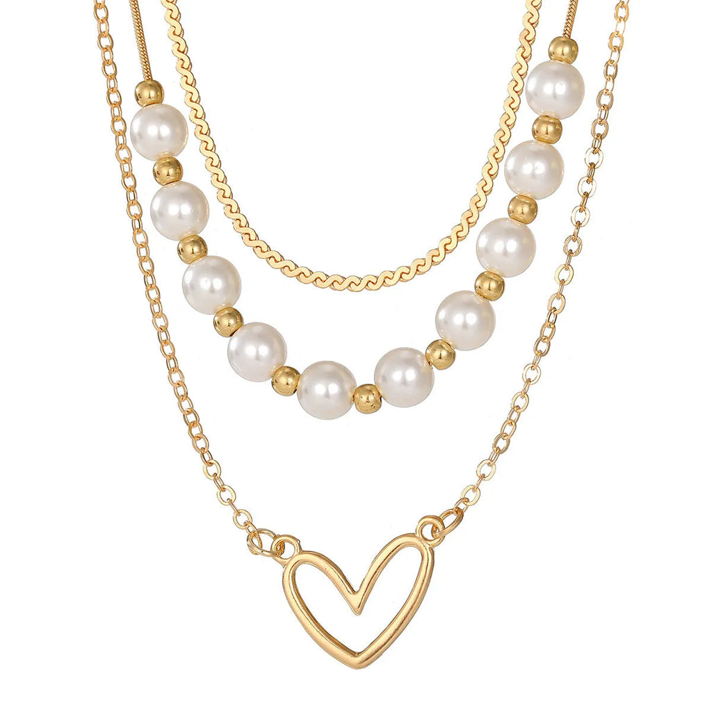 Vintage love heart pearl gold necklace with electroplated alloy pendant and adjustable pearl chain on a white background