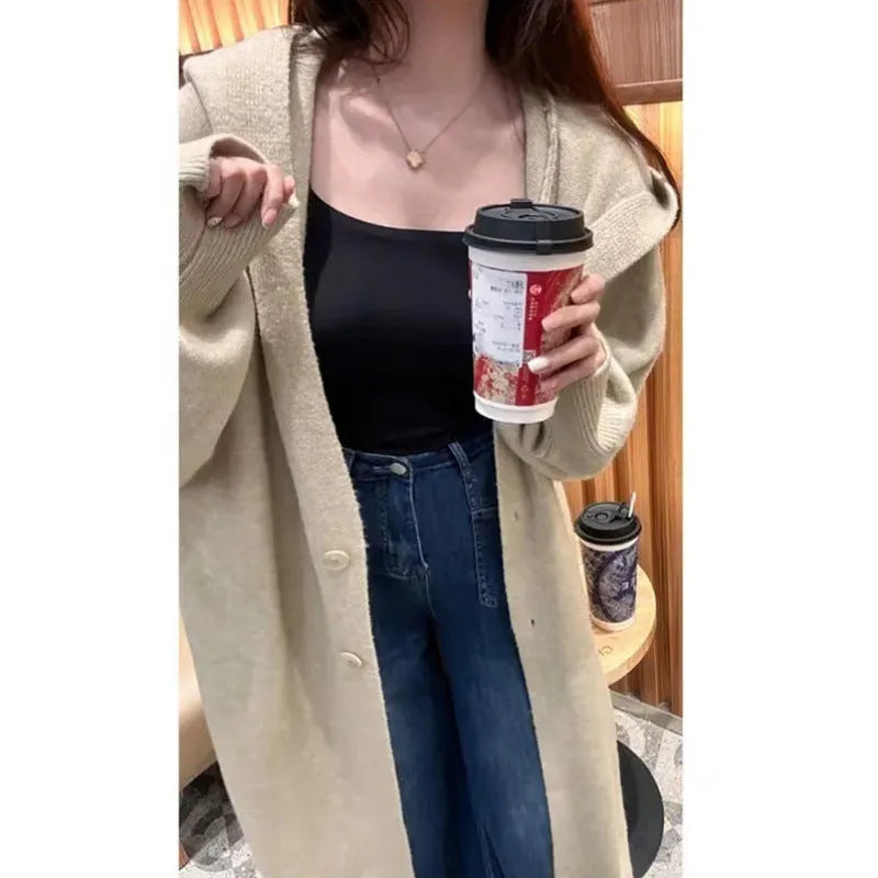 Long brown hooded knitted cardigan for women in a loose, below-the-knee fit.