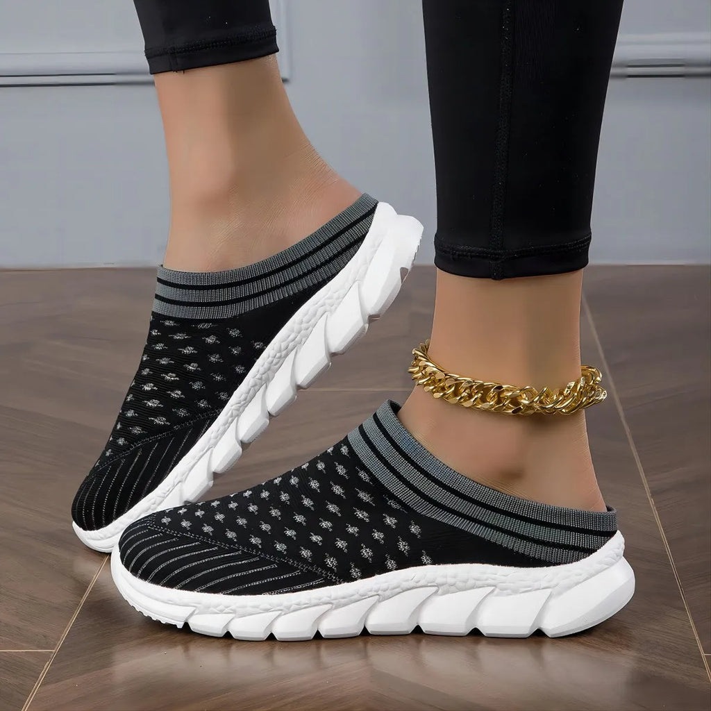 Women's striped Flyknit sports slipper in black with hollowed-out design and height-increasing sole.