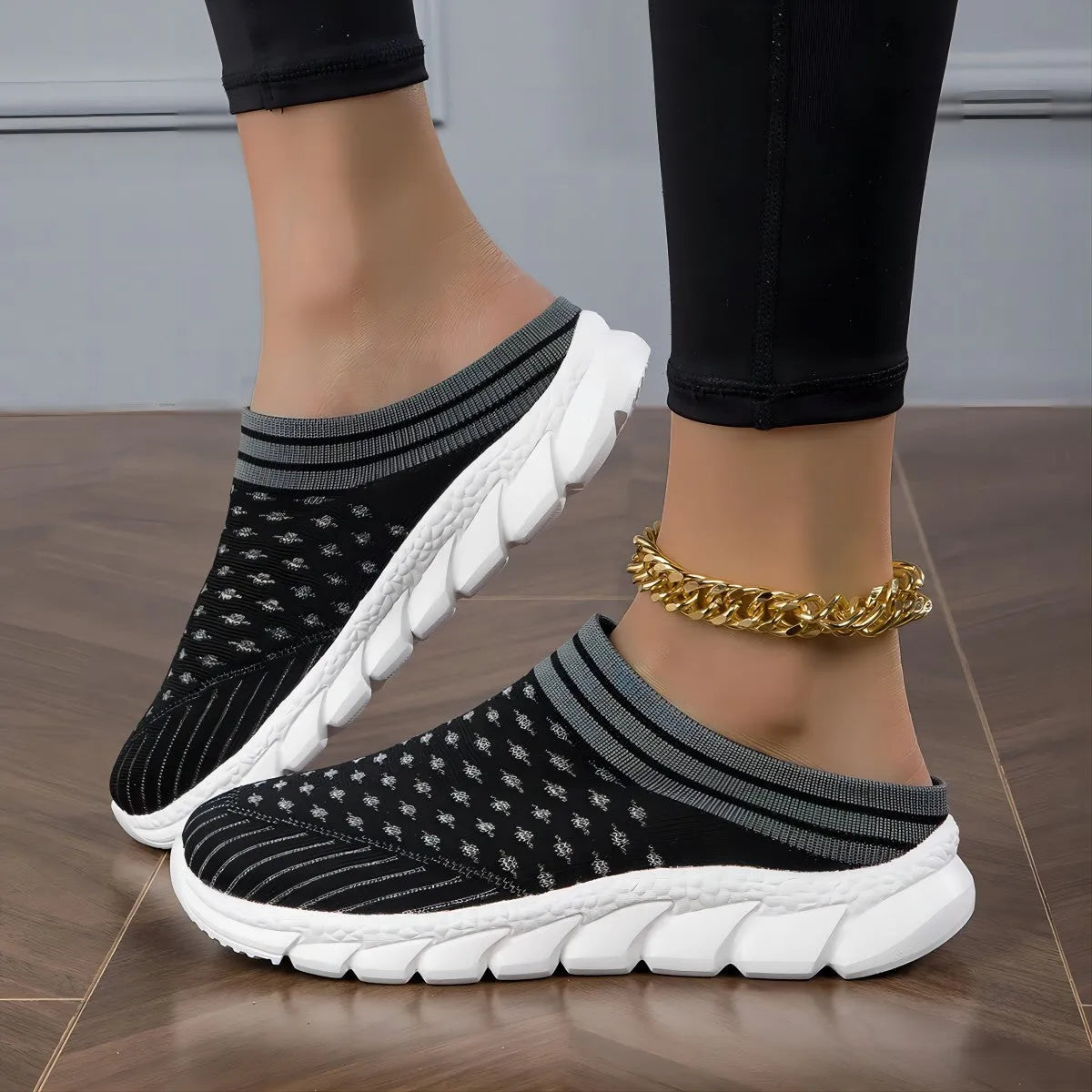 Women's striped Flyknit sports slipper in black with hollowed-out design and height-increasing sole.
