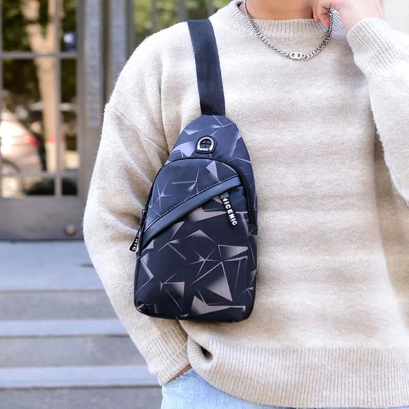Men's blue Oxford cloth crossbody sling bag with an earphone hole and zipper, shown in a square vertical shape.