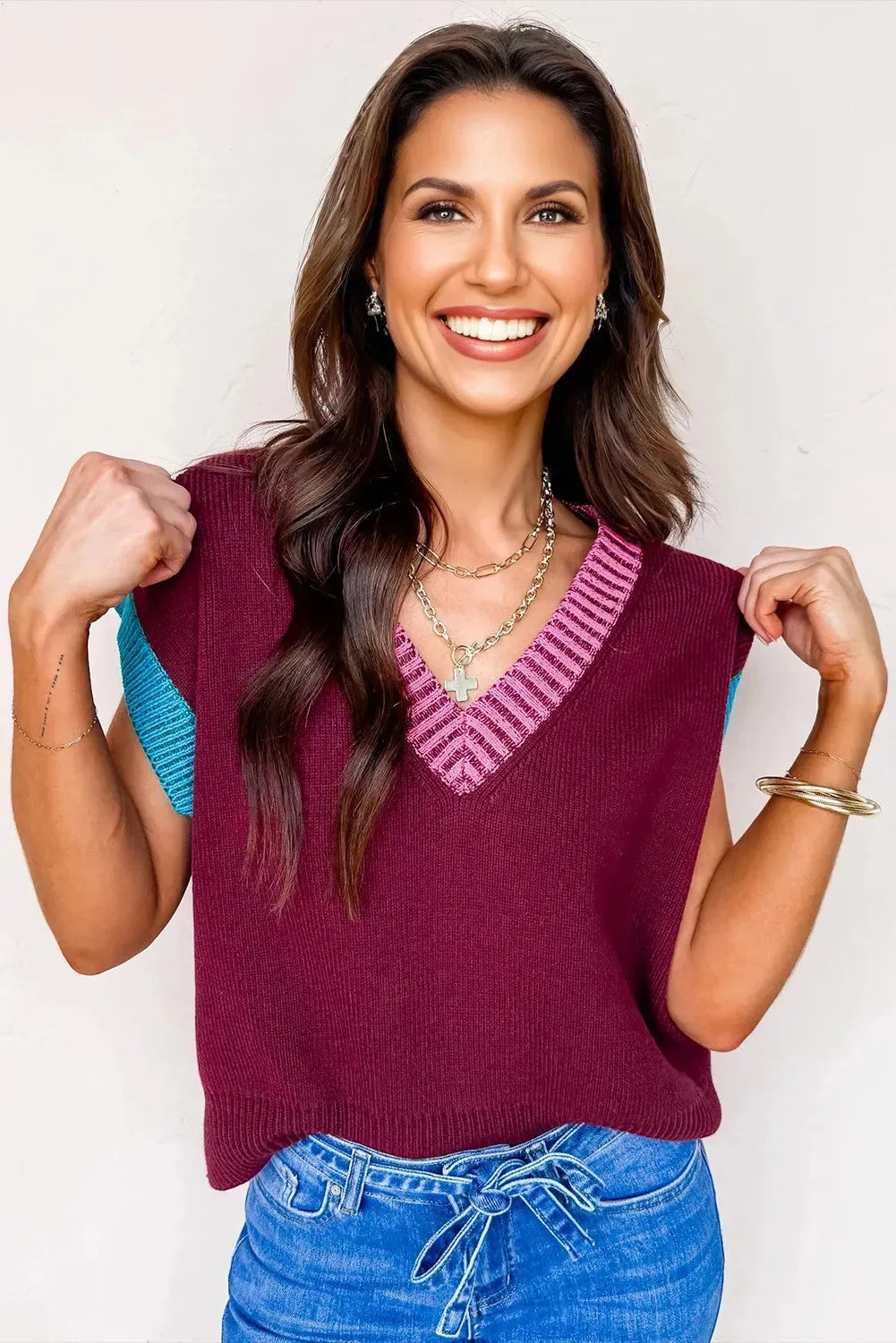 Burgundy women's loose V-neck sweater with contrast trim on short cuffed sleeves.