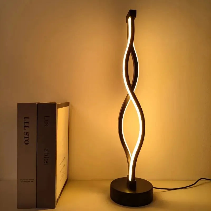 Black aluminium desktop table lamp with dimming button and touch controls.