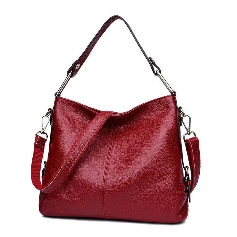 Genuine leather vertical square crossbody bag showing multiple internal pockets including a zipper changing bag and mobile phone pocket.