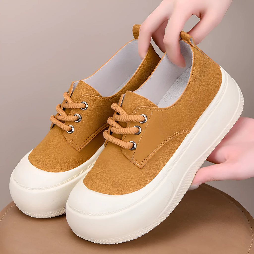 Women's camel suede platform loafers with round toe and front lace-up on a flat rubber sole.