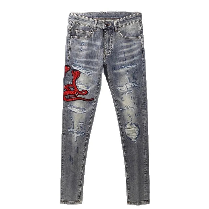 Old colour slim fit jeans with washed-out finish and embroidered hole patches