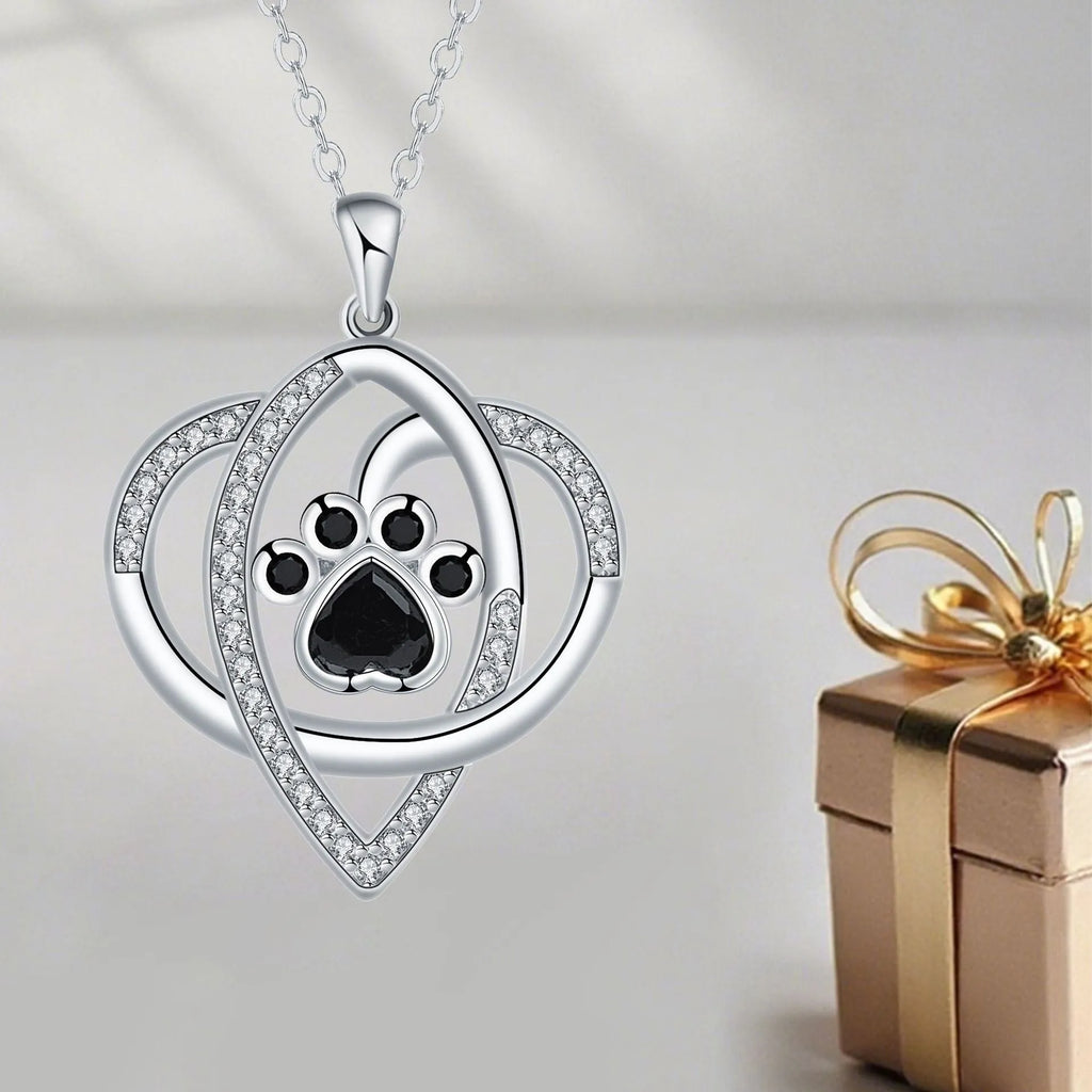 Copper necklace for women with a dog's paw print pendant on a cross chain.