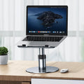 Silver aluminium car laptop stand with adjustable height and a 360-degree rotating base on a car seat.
