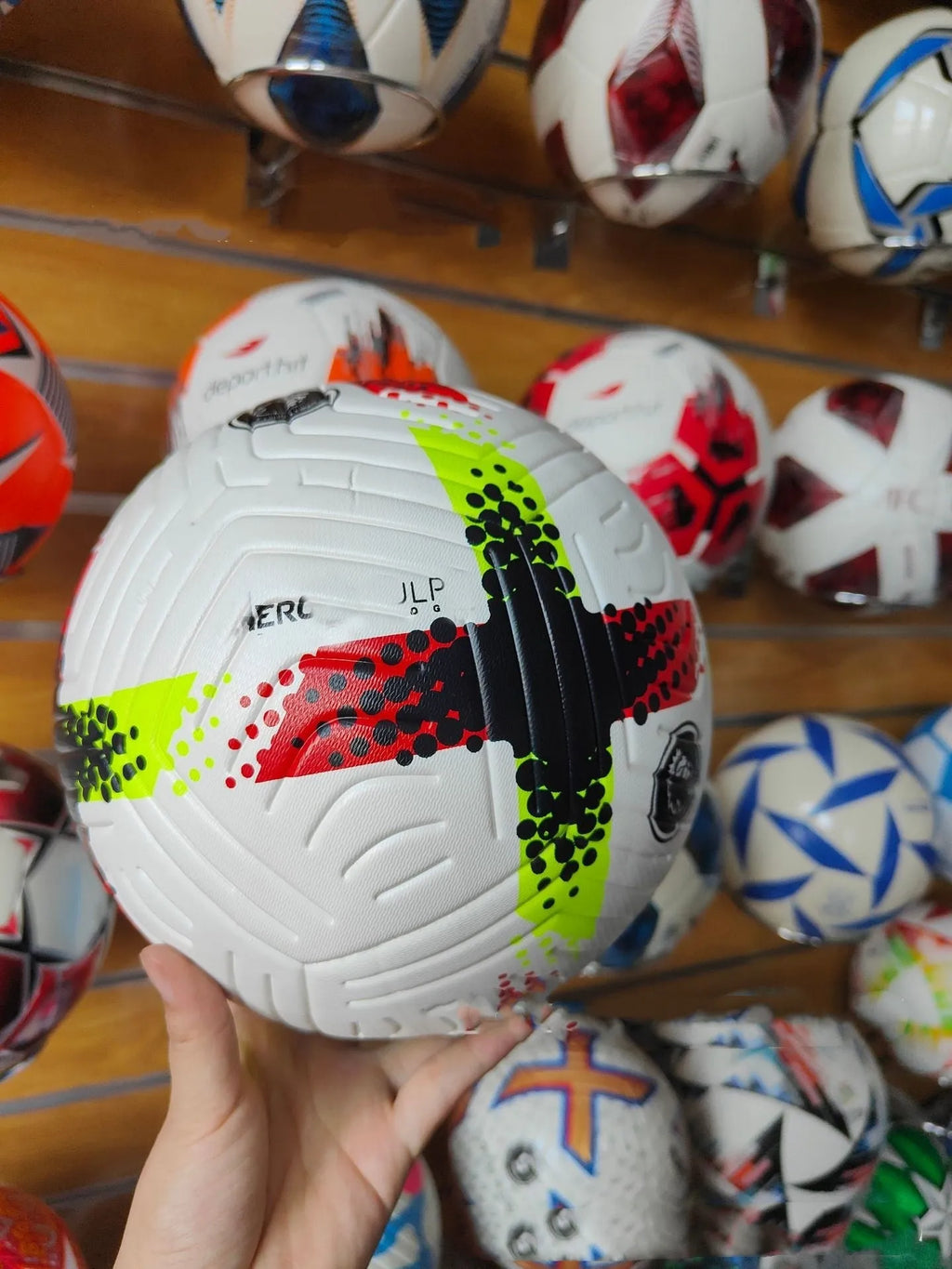 Fluorescent green size 5 PU football with seamless thermal adhesive patch construction.