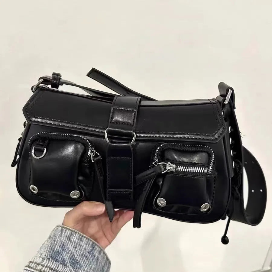 Black underarm baguette messenger bag with adjustable shoulder strap showing structured design