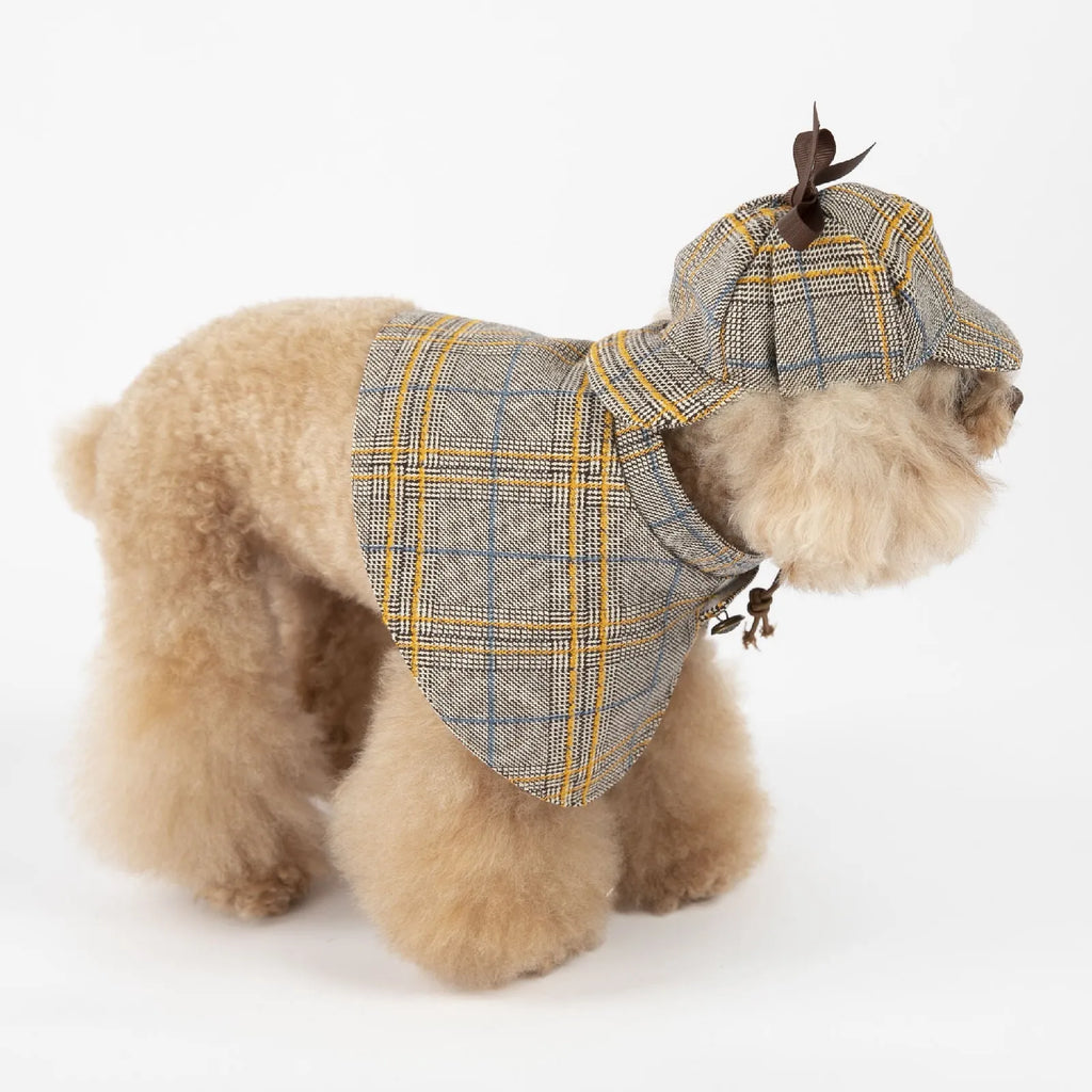 Camel-coloured detective-style cotton cloak for a small dog on a harness, showing the adjustable hat.