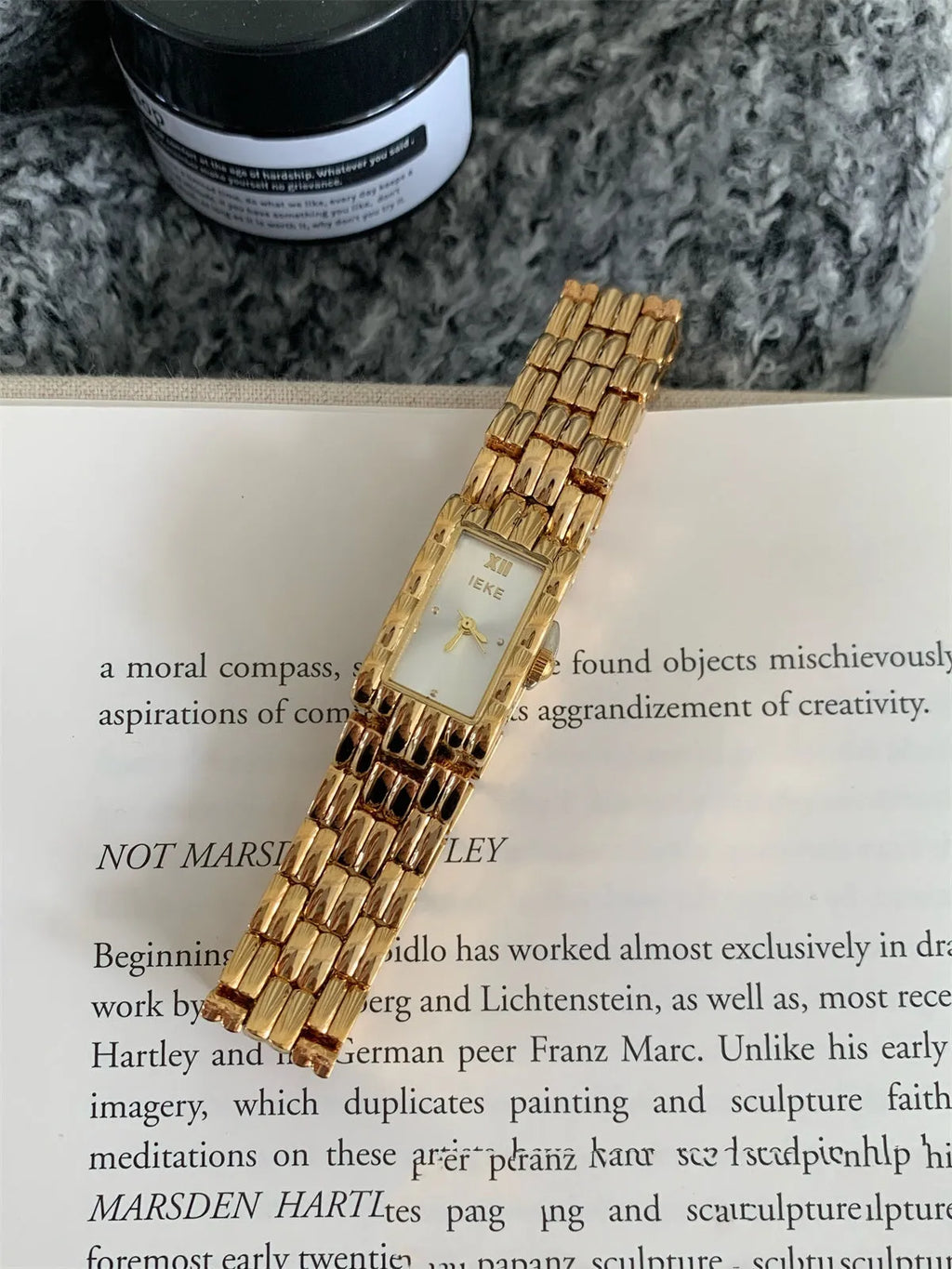 Women's silver and gold bracelet-style watch with 15mm dial and butterfly clasp