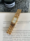 Women's silver and gold bracelet-style watch with 15mm dial and butterfly clasp