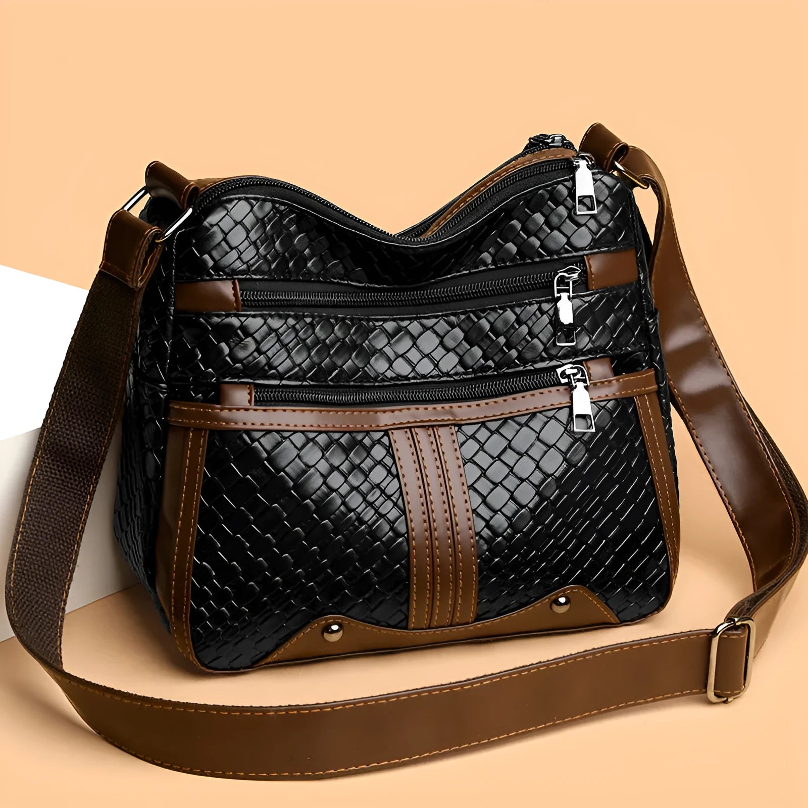 Multi-compartment woven PU messenger bag in brown, horizontal shape with single shoulder strap