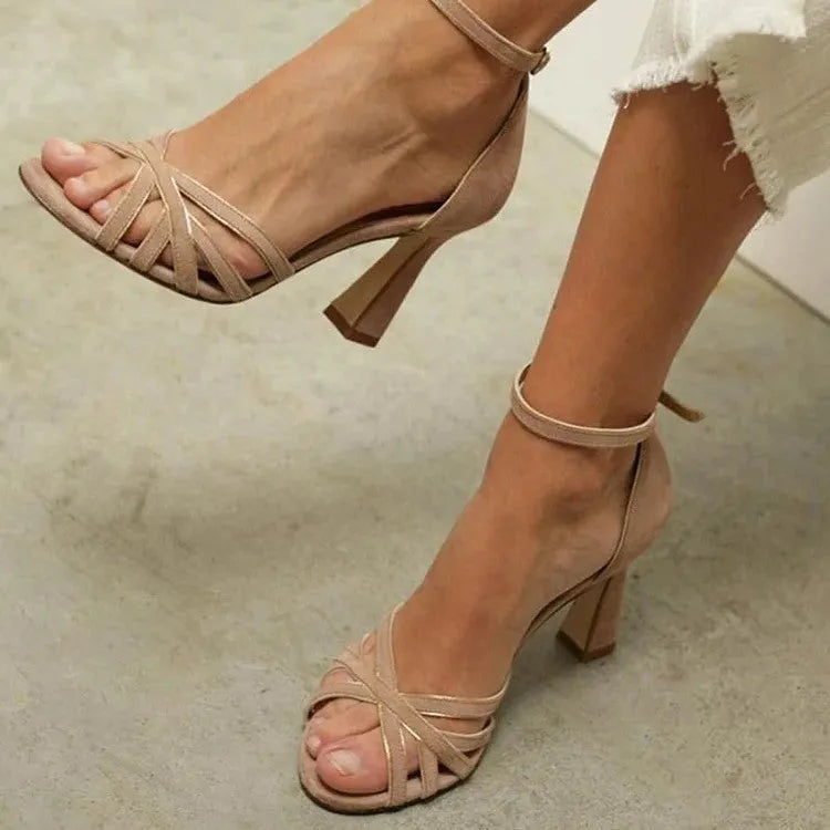 Apricot coloured suede women's sandals with a peep toe and a bag style heel on a rubber sole.