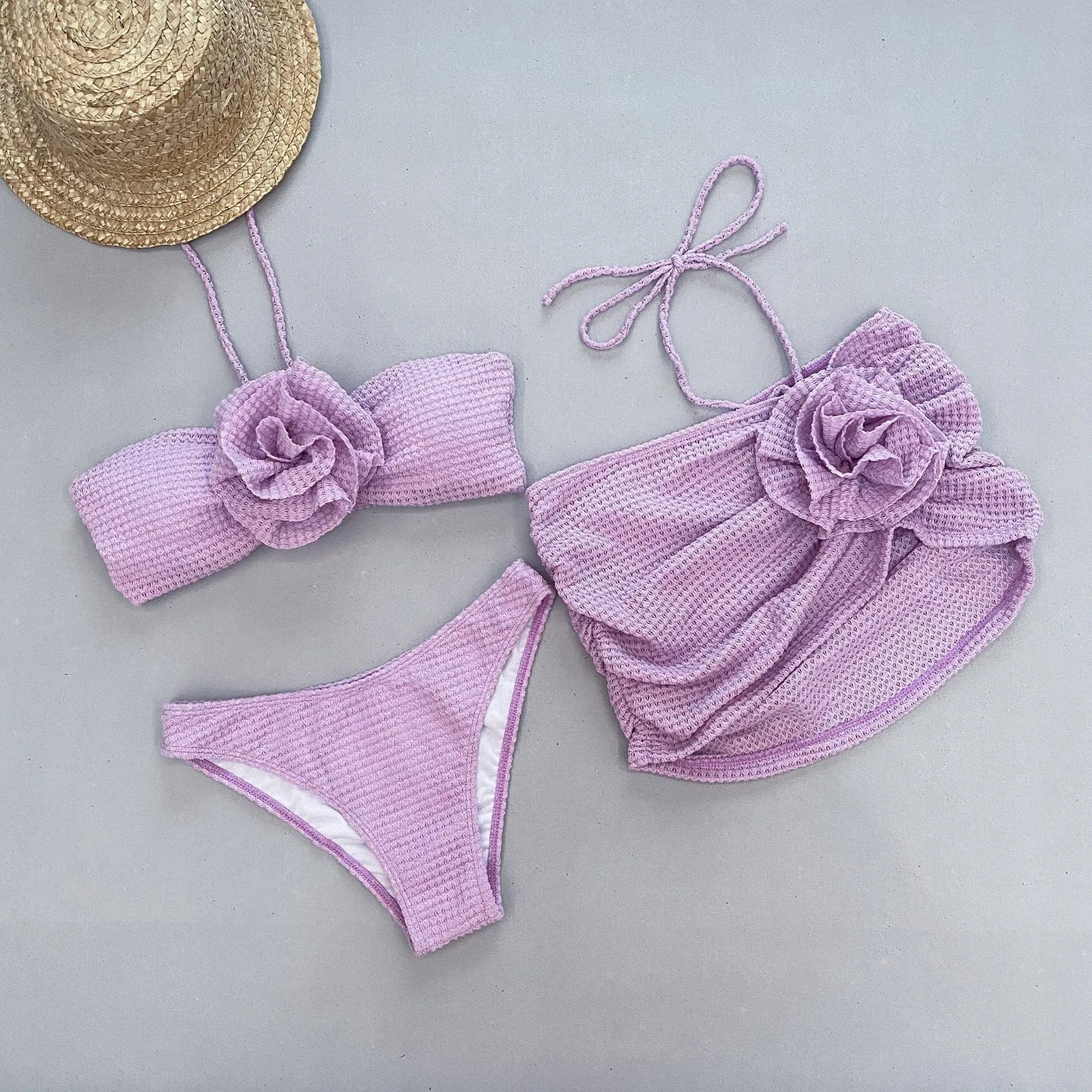 Women's purple and white 3D flower split bikini set with bra, panties, and skirt.