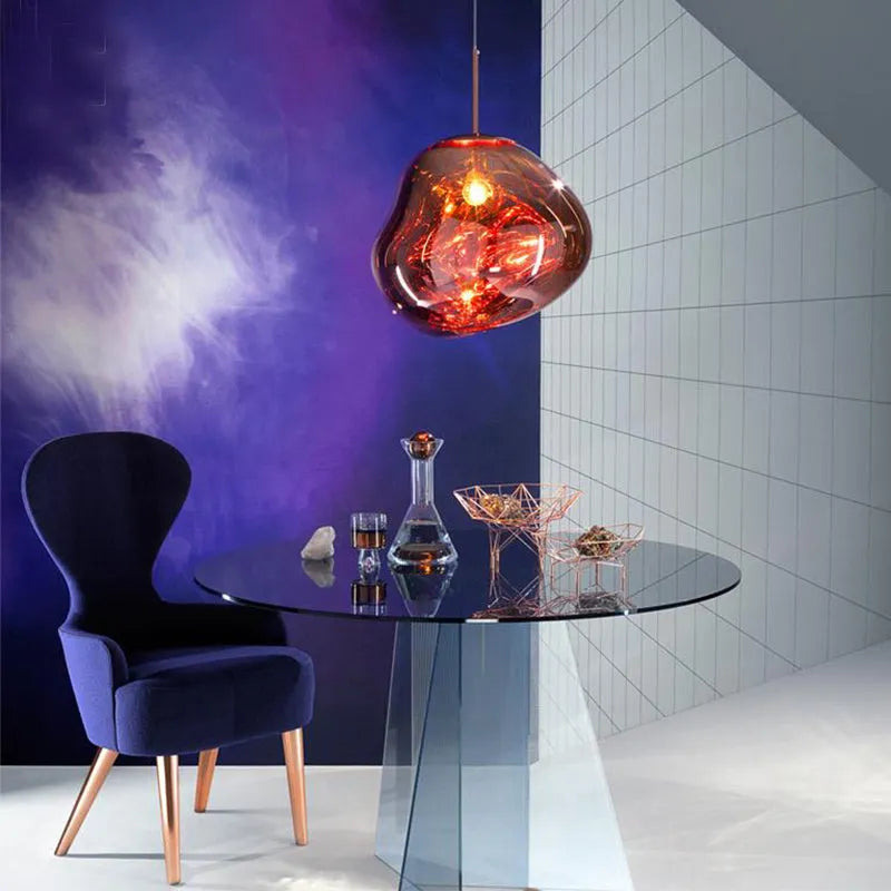 Nordic post-modern lava lamp chandelier with glass body and metallic finish in bedroom setting