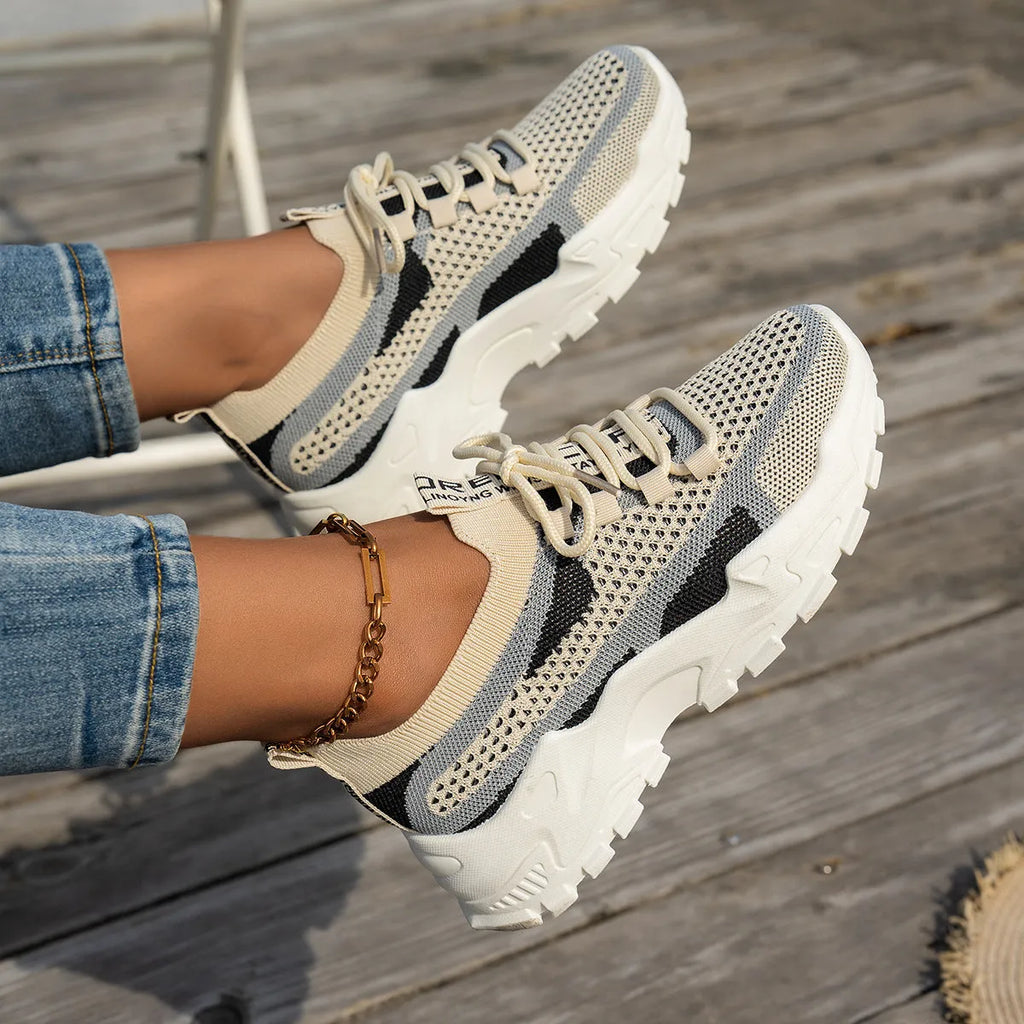 Women's Flyknit mesh lace-up sneakers in multiple colours on a white background.