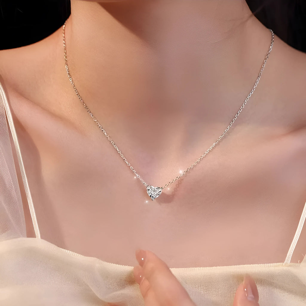 Women's simple heart-shaped copper necklace with a silver colour finish on a white background.