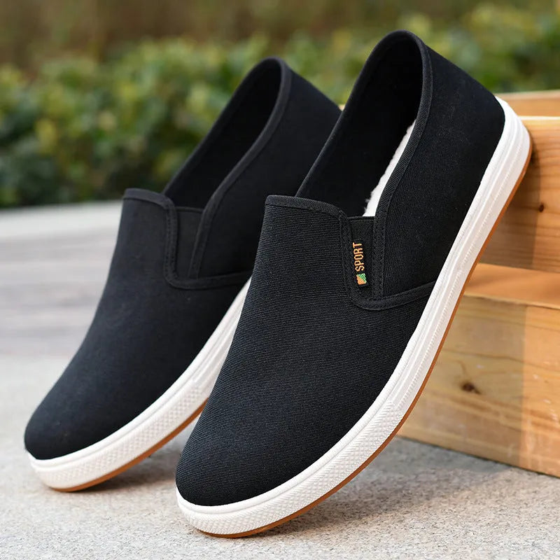 Men's low-top canvas slip-on shoes in blue colour showing round-toe design and composite soles