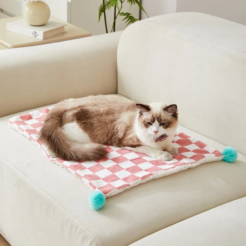 Plush pet blanket with plaid pattern and fur ball decoration for cats and dogs
