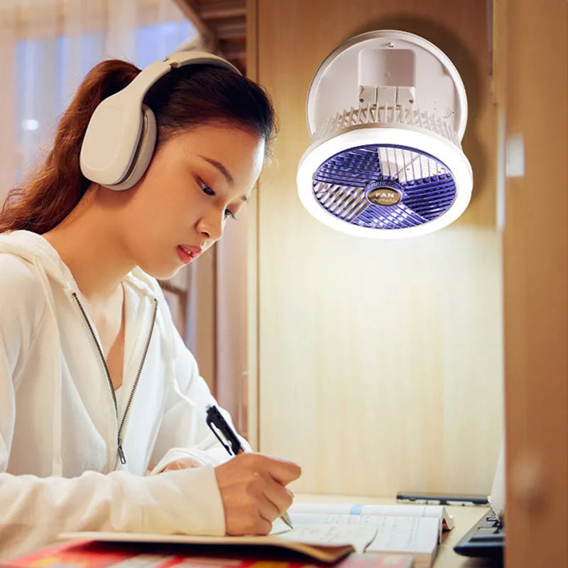 Blue USB foldable table fan with LED night light, pen holder, and four speed settings on a desk