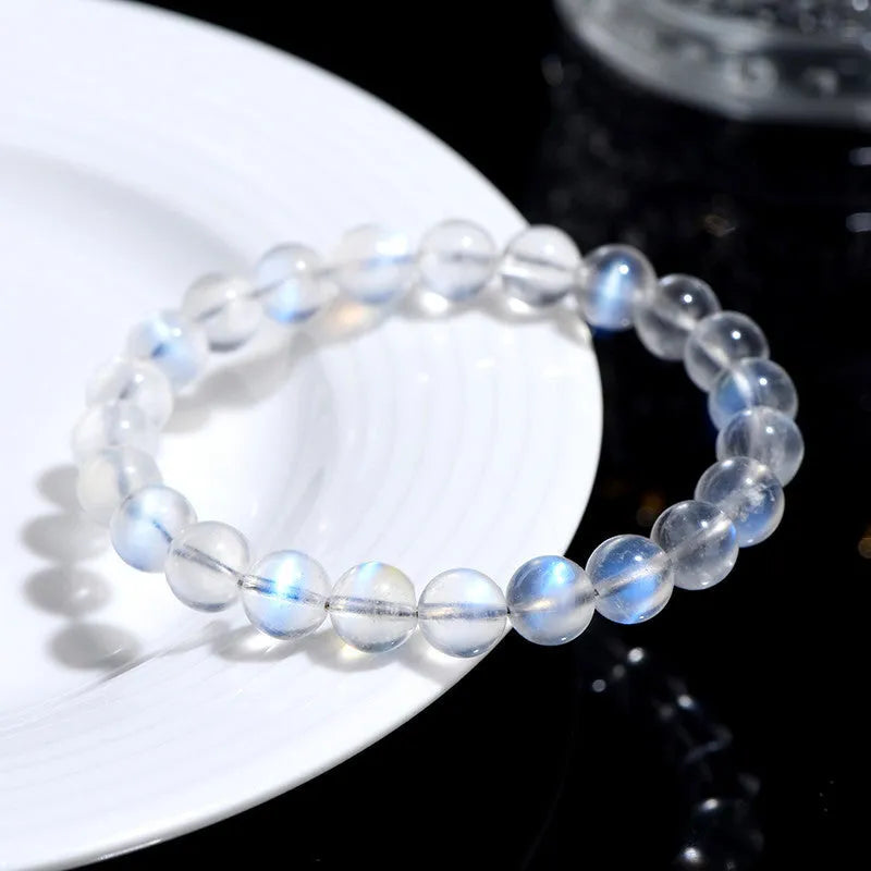 Natural cream body blue moonlight crystal bracelet with matte finish on a wrist.