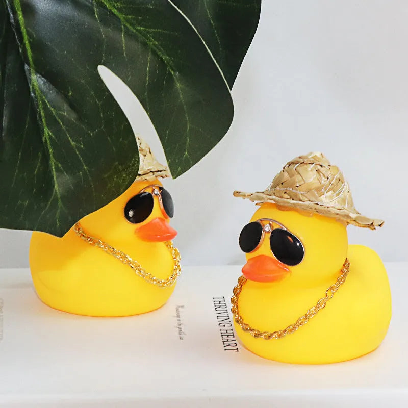 Straw hat yellow duck cartoon car dashboard ornament with adhesive gel and sunglasses necklace.
