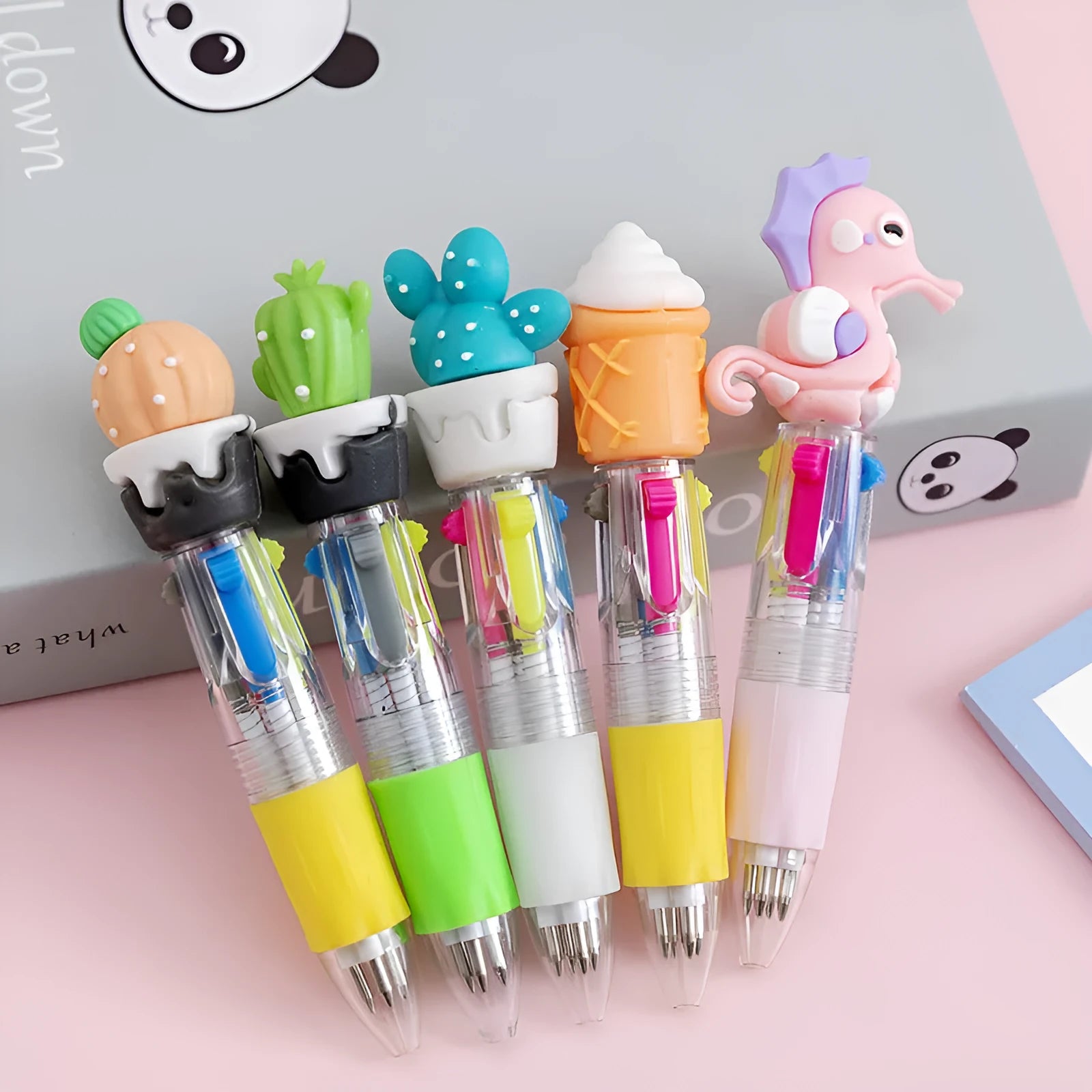 Cute cartoon-themed four-colour press-action ballpoint pen with plastic and silicone body.