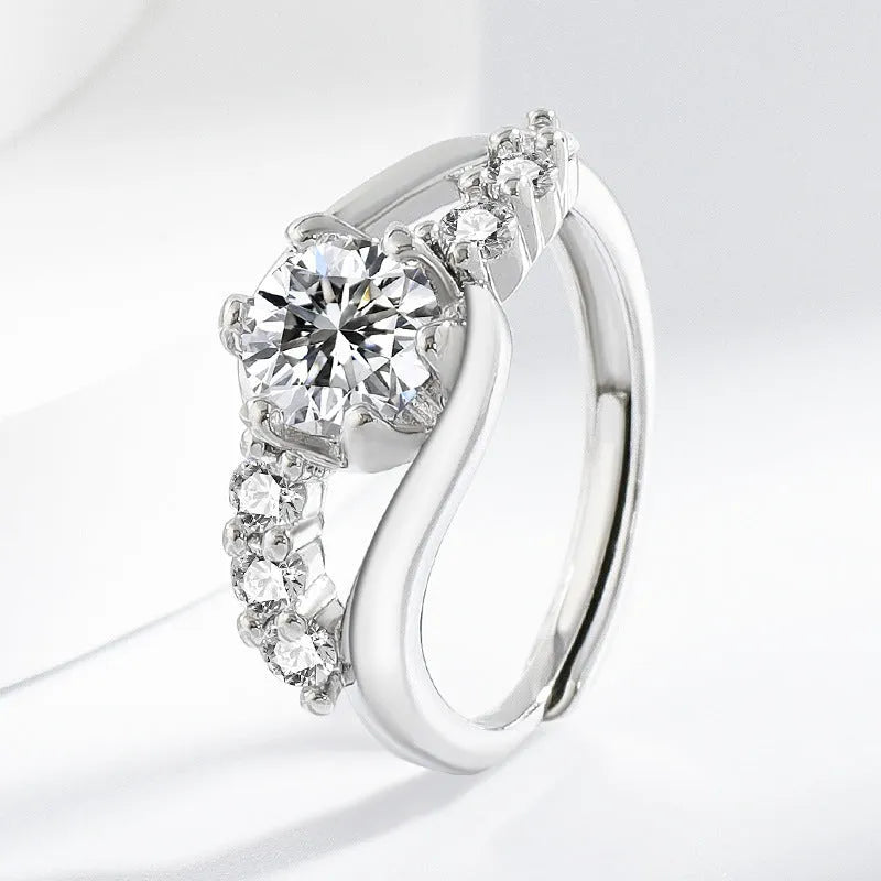 White gold colour crown-shaped copper ring on a plain background