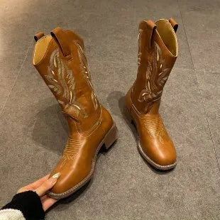 Brown women's mid-calf Martin boots with embroidered pattern, leather lining, and a lace-up front.