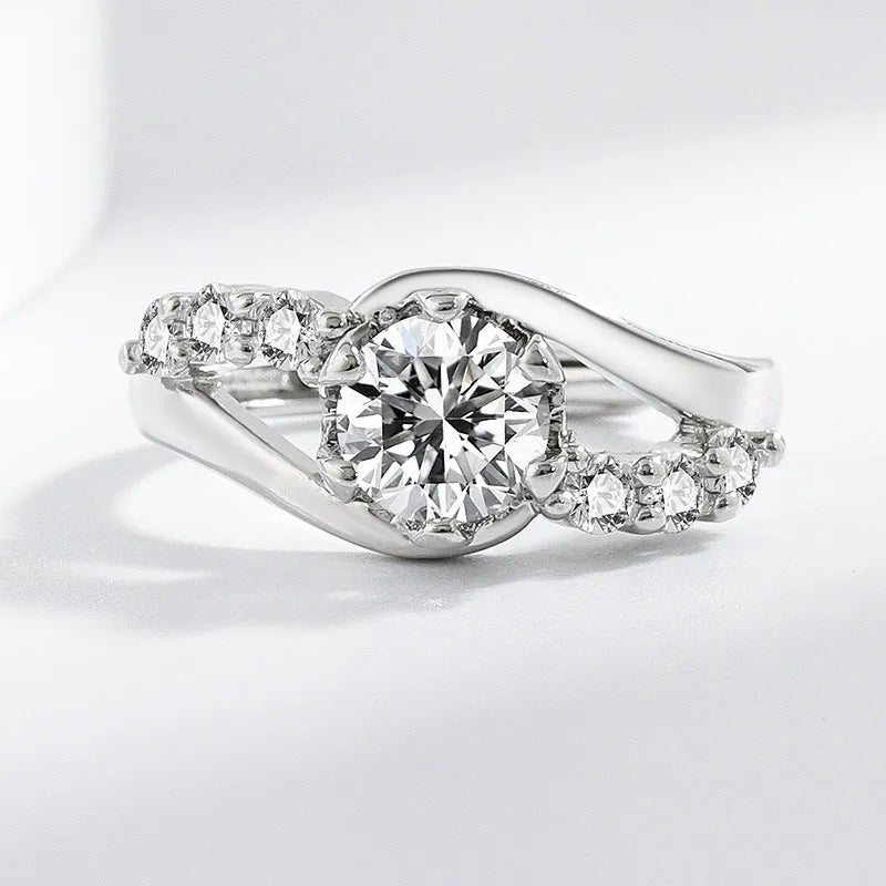 White gold colour crown-shaped copper ring on a plain background
