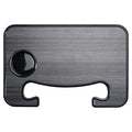 Black car steering wheel laptop tray mounted on vehicle steering wheel with laptop placed on surface