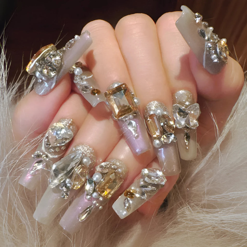 False nail patches with rhinestone embellishments in S number sizing on card paper packaging
