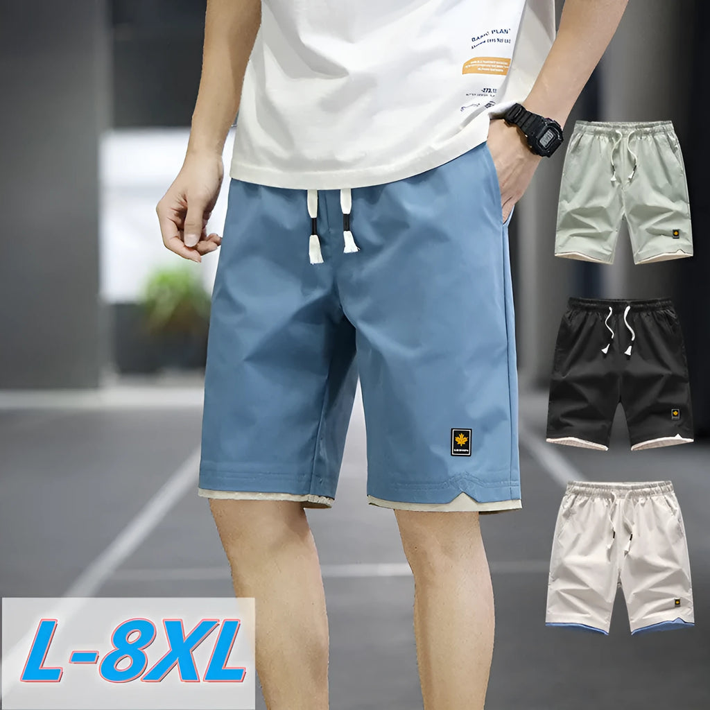 Man wearing green straight-leg loose fit casual beach shorts made from polyester.