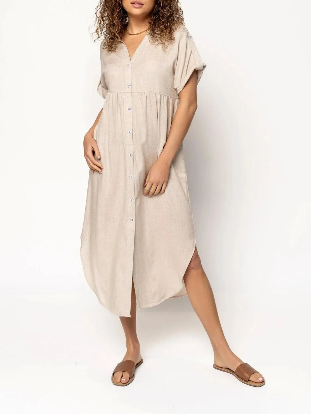 A loose-fitting, mid-length casual dress with a button-down front, shown in a solid colour.