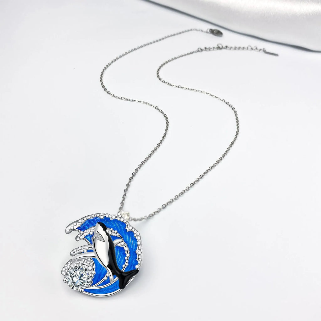 Women's silver-tone necklace with a detailed shark pendant on a cross chain.