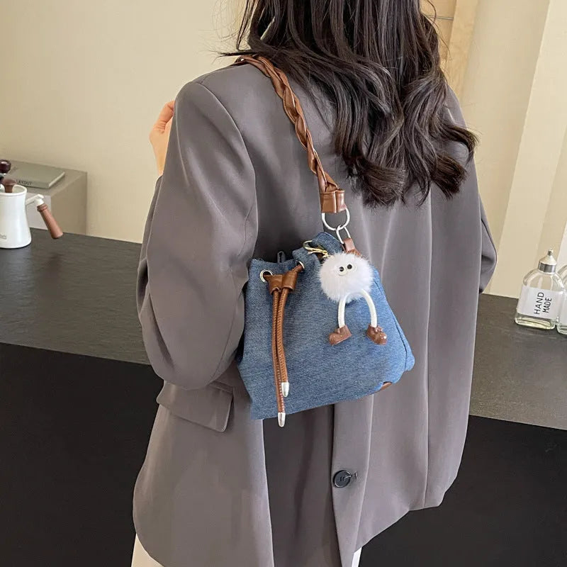 Blue one-shoulder cross body bucket bag with sandwich pocket compartments