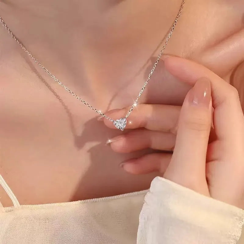 Women's simple heart-shaped copper necklace with a silver colour finish on a white background.