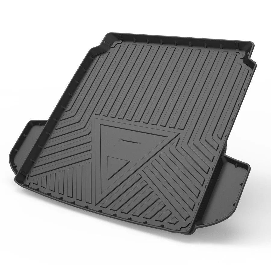 Black carbon fibre pattern TPE car boot liner mat fitted in a hatchback trunk.