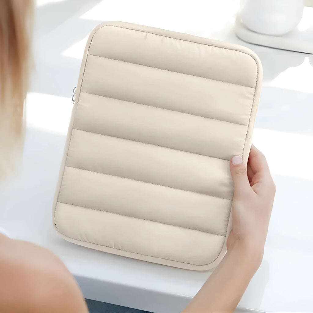 Black elastic puff bag laptop sleeve for 9.7 to 11 inch devices on a table