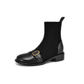 Black women's lace-up Martin boots with low heel and decorative belt buckle stitching on a white background.