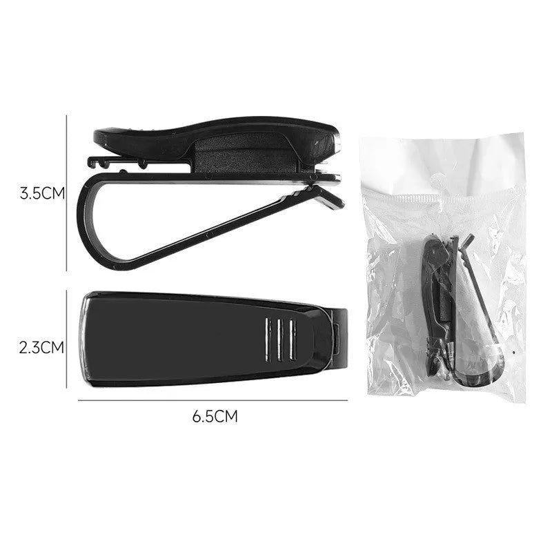 Black plastic multifunctional clip for car sun visors, designed to hold sunglasses and cards.