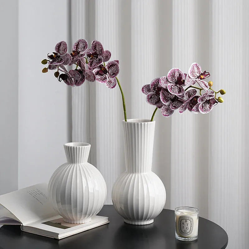 White ceramic ball vase with stripes, American country style, shown on a table.