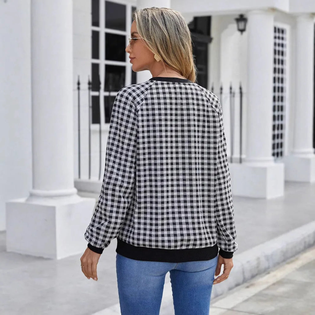 Black long sleeve pullover sweater with printed plaid and stripe pattern design.