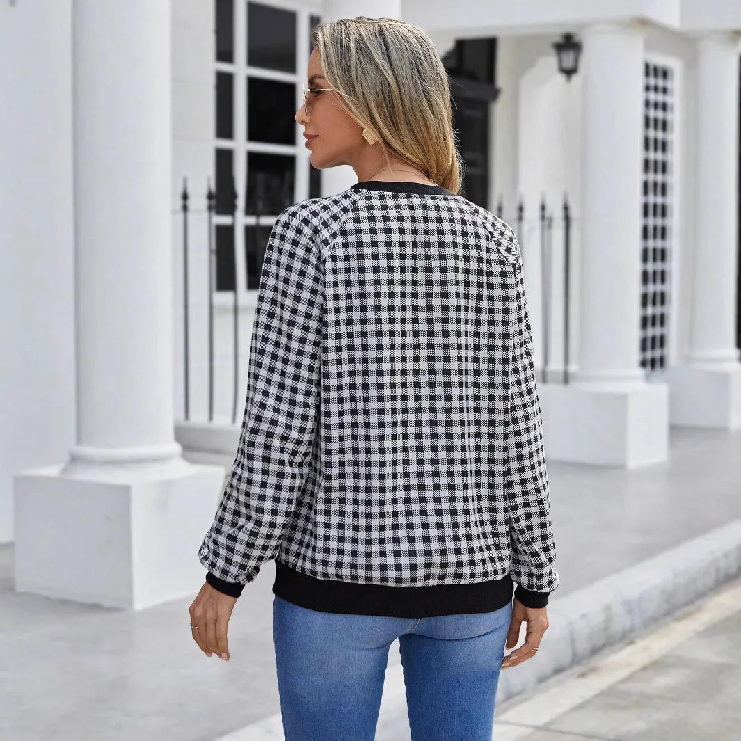 Black long sleeve pullover sweater with printed plaid and stripe pattern design.
