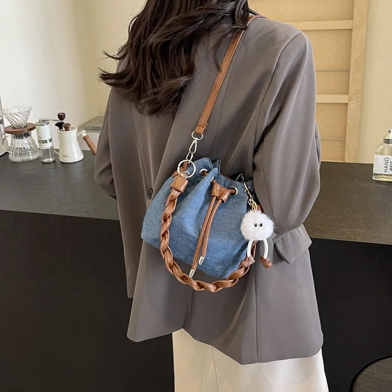 Blue one-shoulder cross body bucket bag with sandwich pocket compartments