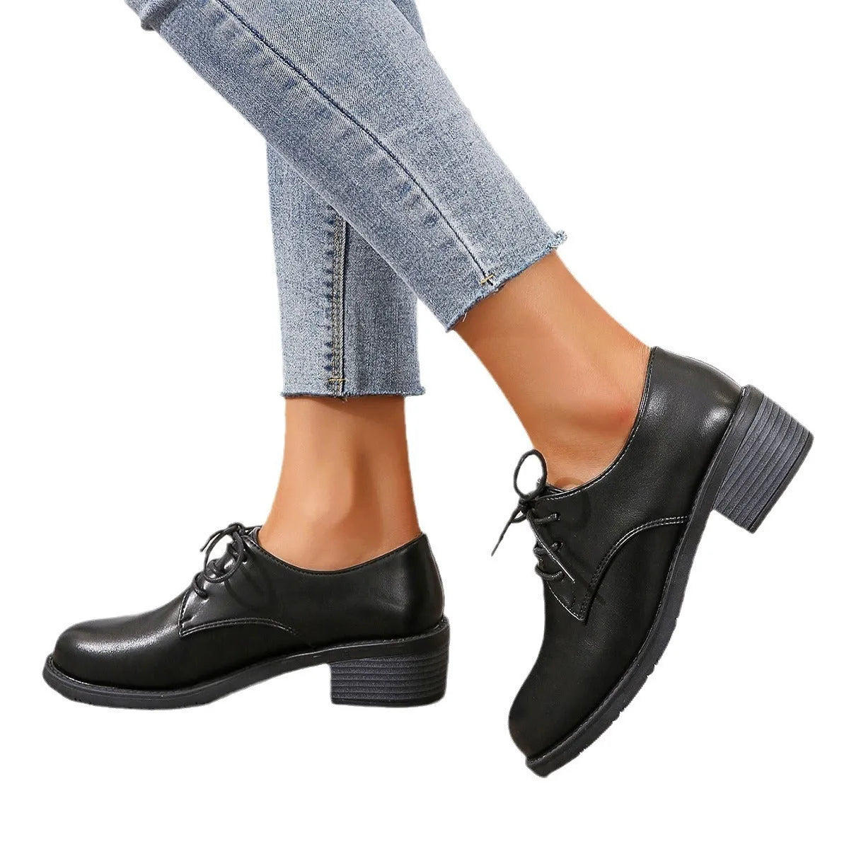 Black women's work shoes with a thick chunky heel and pointed toe.