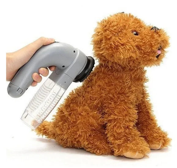 Grey portable electric pet hair remover brush with soft rubber head for grooming dogs and cats.
